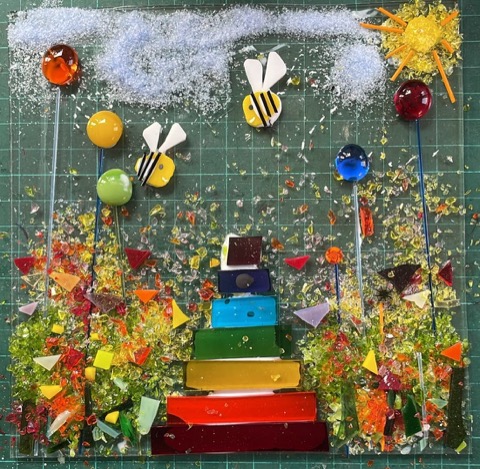 Fused glass garden scene with bees, rainbow stack and sun