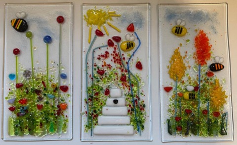 Three fused glass panels with bees and flowers