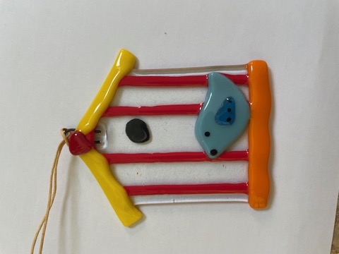 Yellow-roofed fused glass birdhouse with blue bird and red stripes
